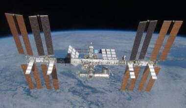 An image of the International Space Station, with its many solar panels and modules, floating above Earth in space