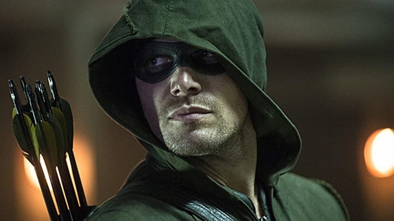 Oliver Queen (Stephen Amell) is dressed as Green Arrow on Arrow