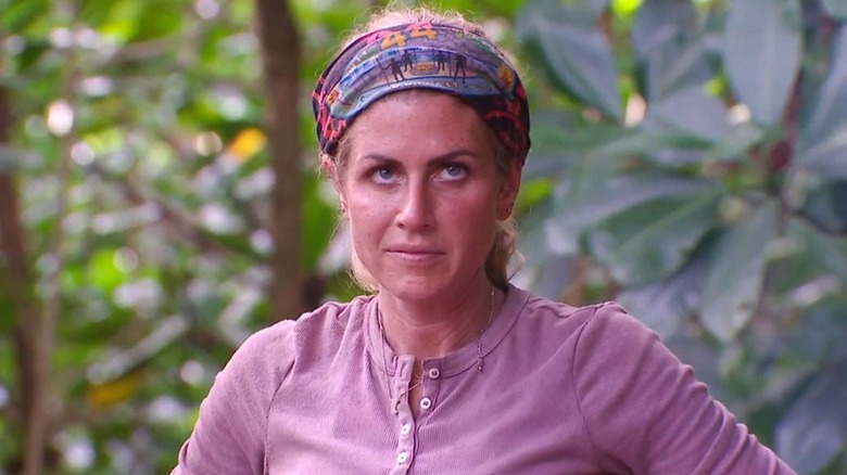 Carolyn looking skeptical wearing her buff during a challenge on Survivor