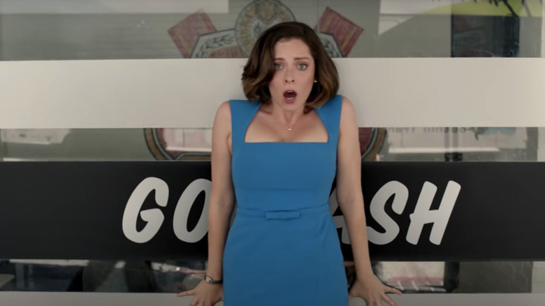Rebecca Bunch (Rachel Bloom) stands shocked in front of a sign on Crazy Ex-Girlfriend