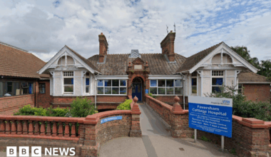 A single-storey building. There is a blue sign out the front which says "Faversham Cottage Hospital".