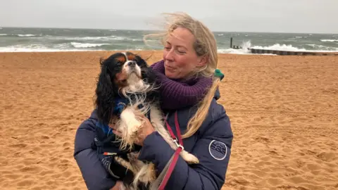 Nicky on the beach at Bournemouth with her King Charles spaniel dog
