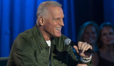 Mel Owens smiles as he talks into a microphone on The Golden Bachelor Season 2.