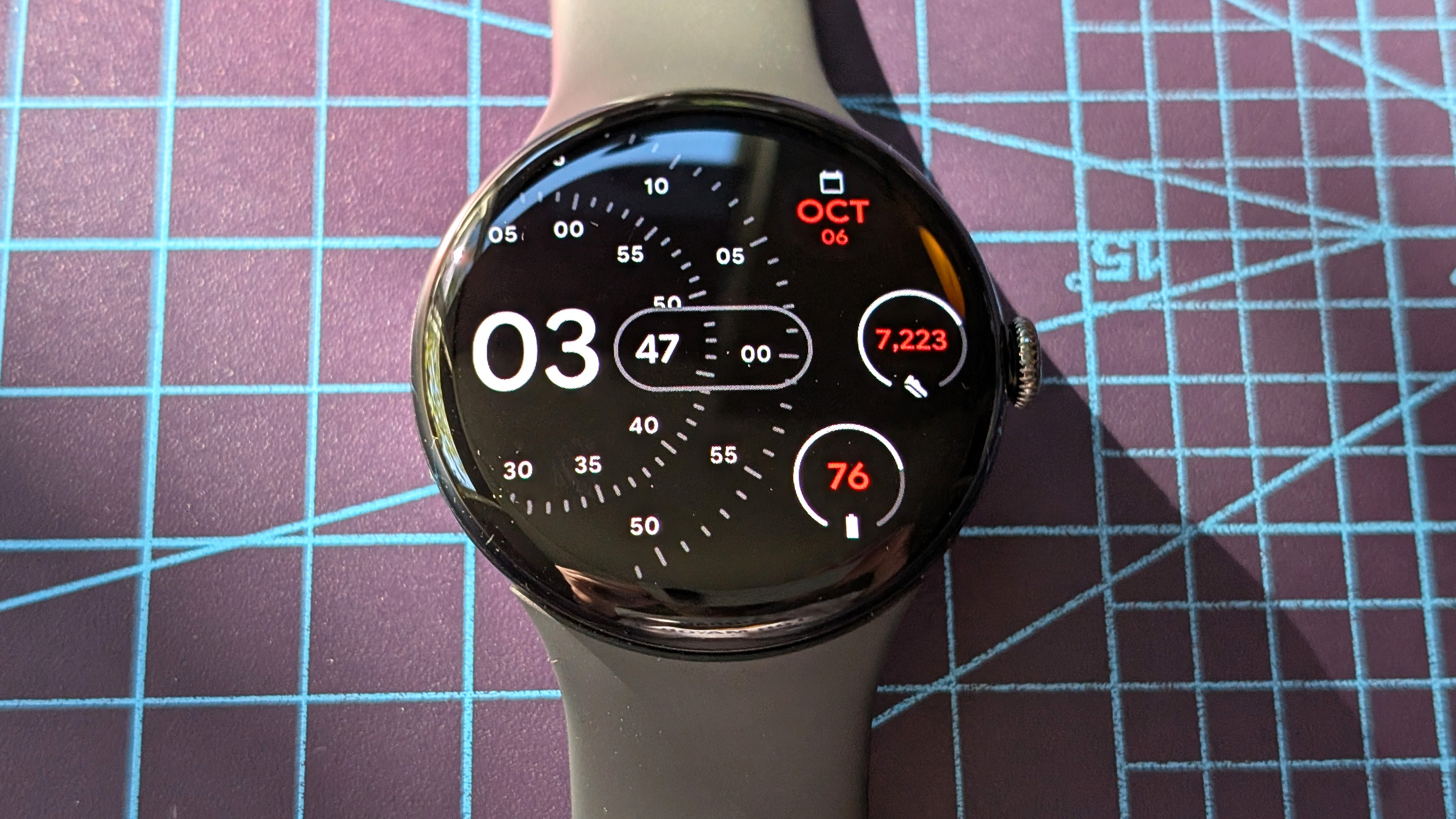 Close-up of the Google Pixel Watch 4 in black on a black strap