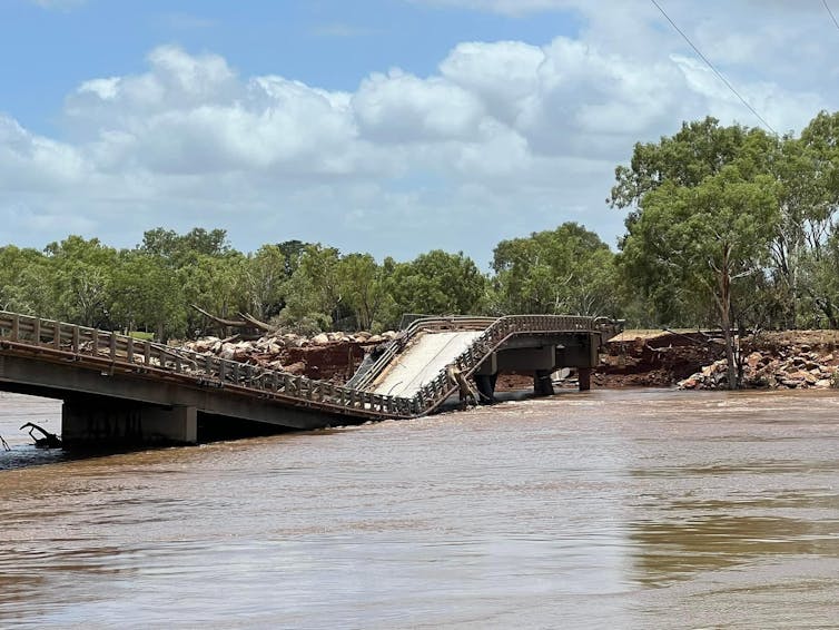 damaged bridge in western australia following floods, a bridge with a broken span and river beneath it.