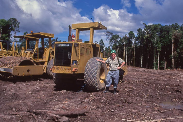 Man stands by tractor