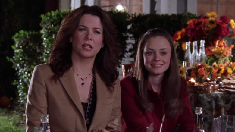Lorelai Gilmore (Lauren Graham) and Rory Gilmore (Alexis Bledel) attend an outdoor gala at night on Gilmore Girls
