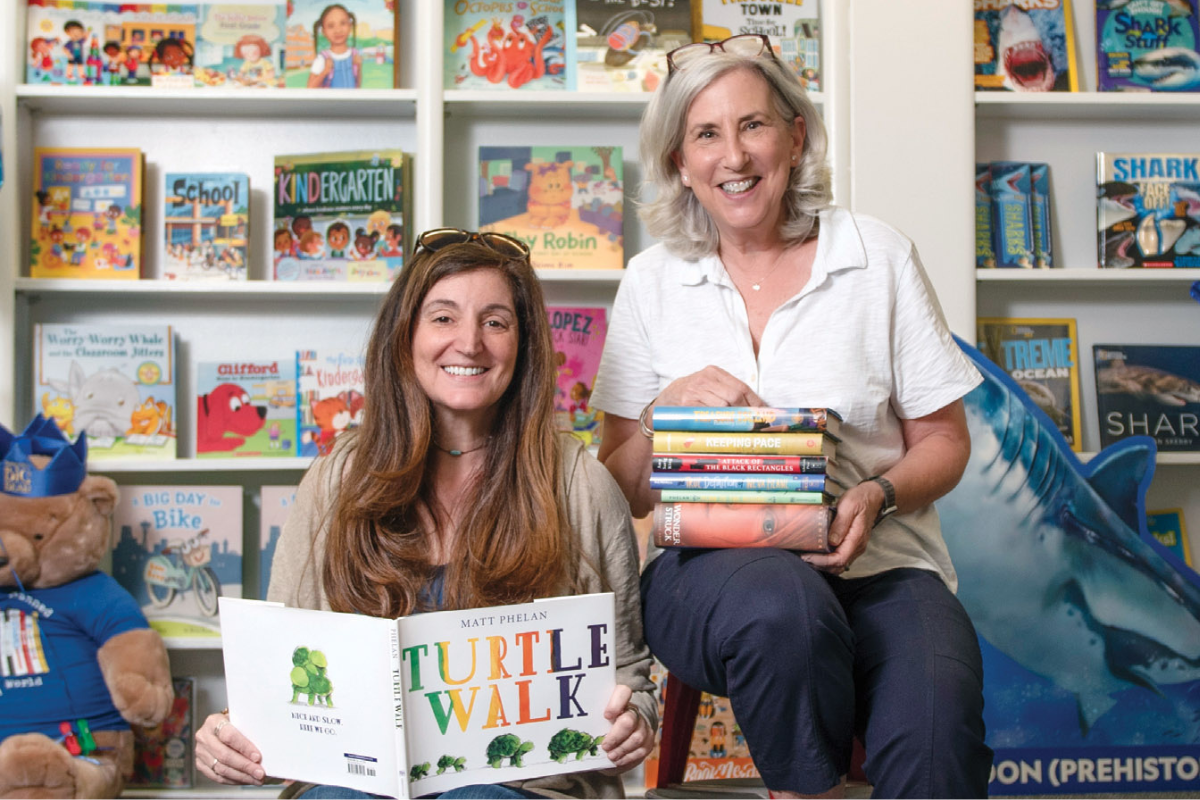 women holding books for Indie Main Line Coalition