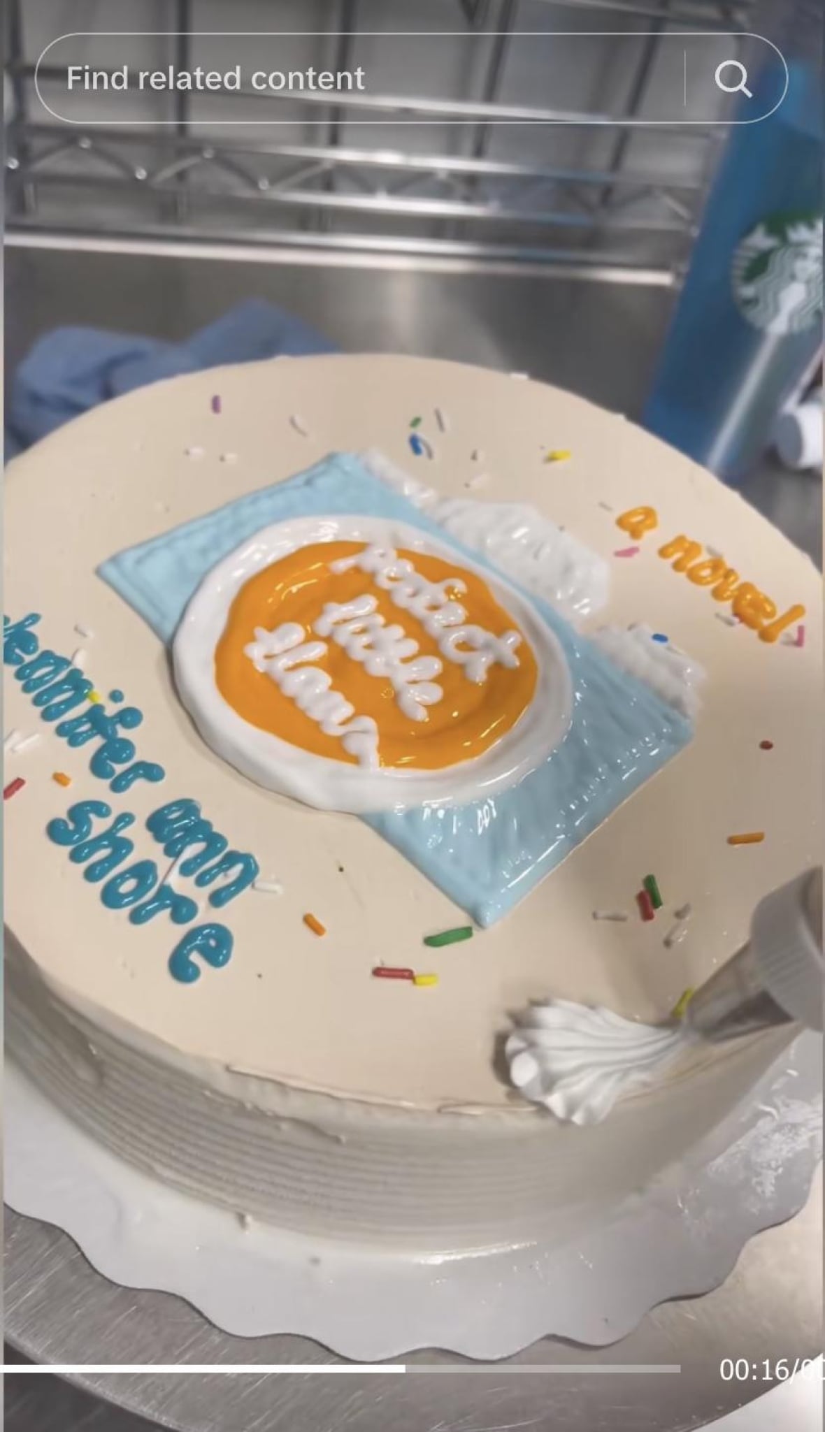 An ice cream cake with a blue and orange camera on it.
