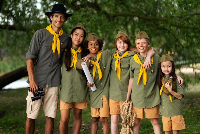 Group of scouts with leader outdoors, symbolizing patients brushing off terrifying symptoms as normal to doctors' horror.