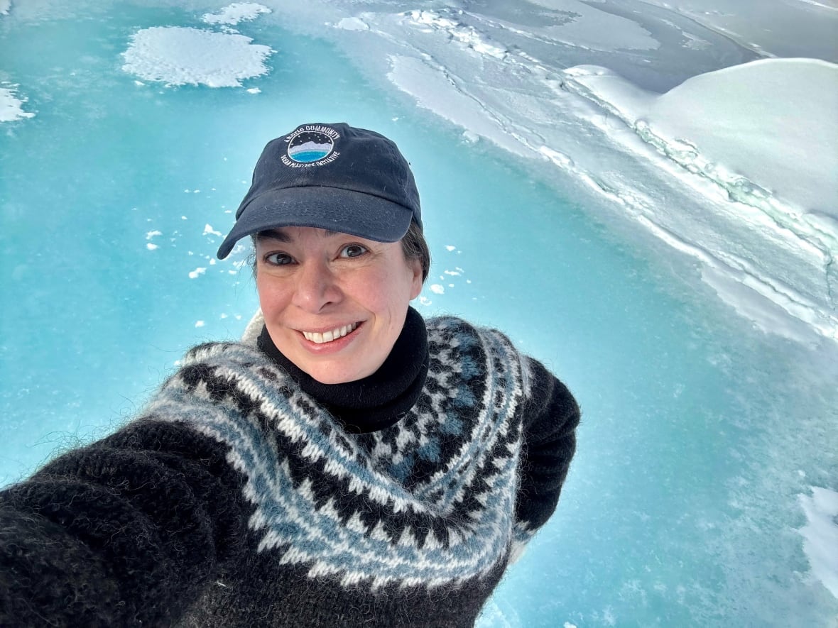 woman stands on sea ice