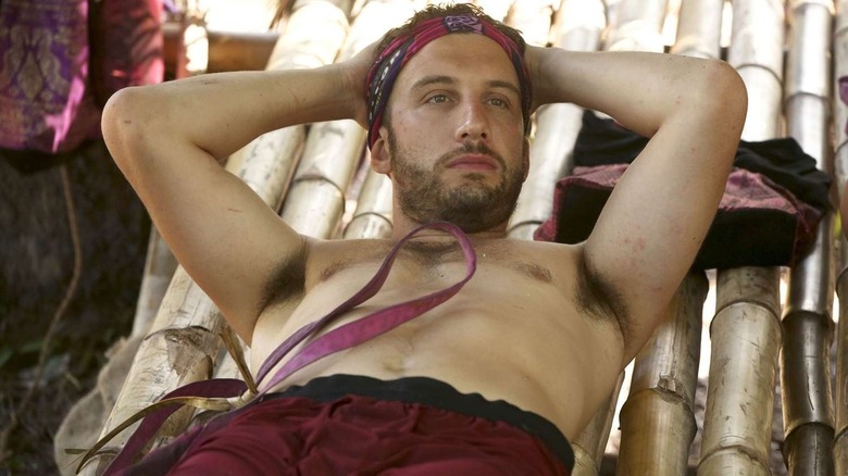 Stephen lounging on a bamboo hammock on Survivor