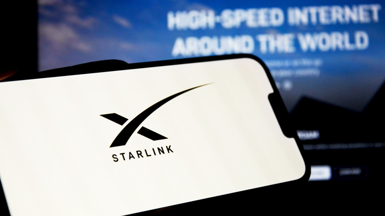 The Starlink logo on a phone screen.