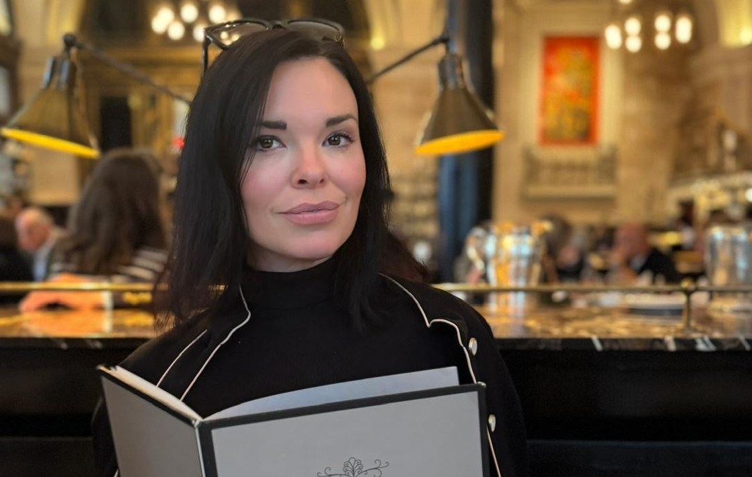 Libby Brodie, a wine consultant from London, holding a wine list at The Wolseley.
