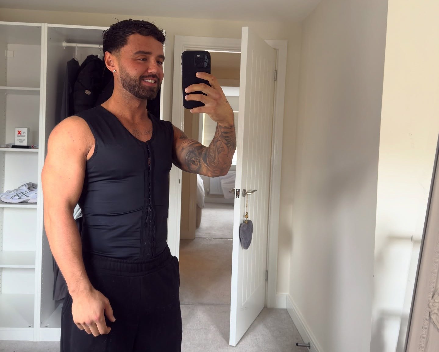 Tom Holbrook, a fitness coach, takes a mirror selfie.