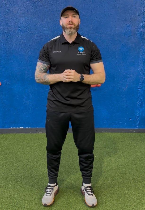 A photo of coach Shane Fallon standing in a gym