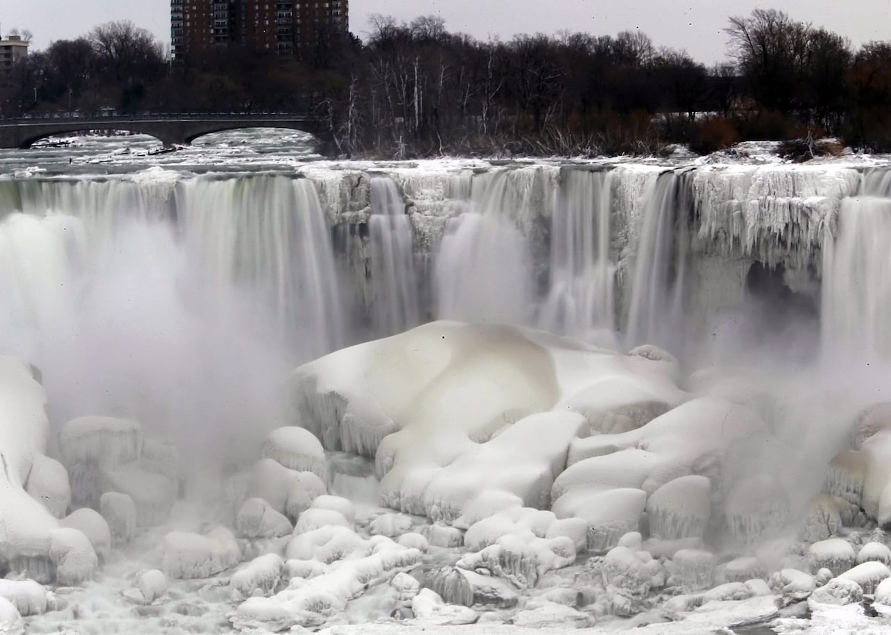 An image of Niagara Falls where most of it is frozen.
