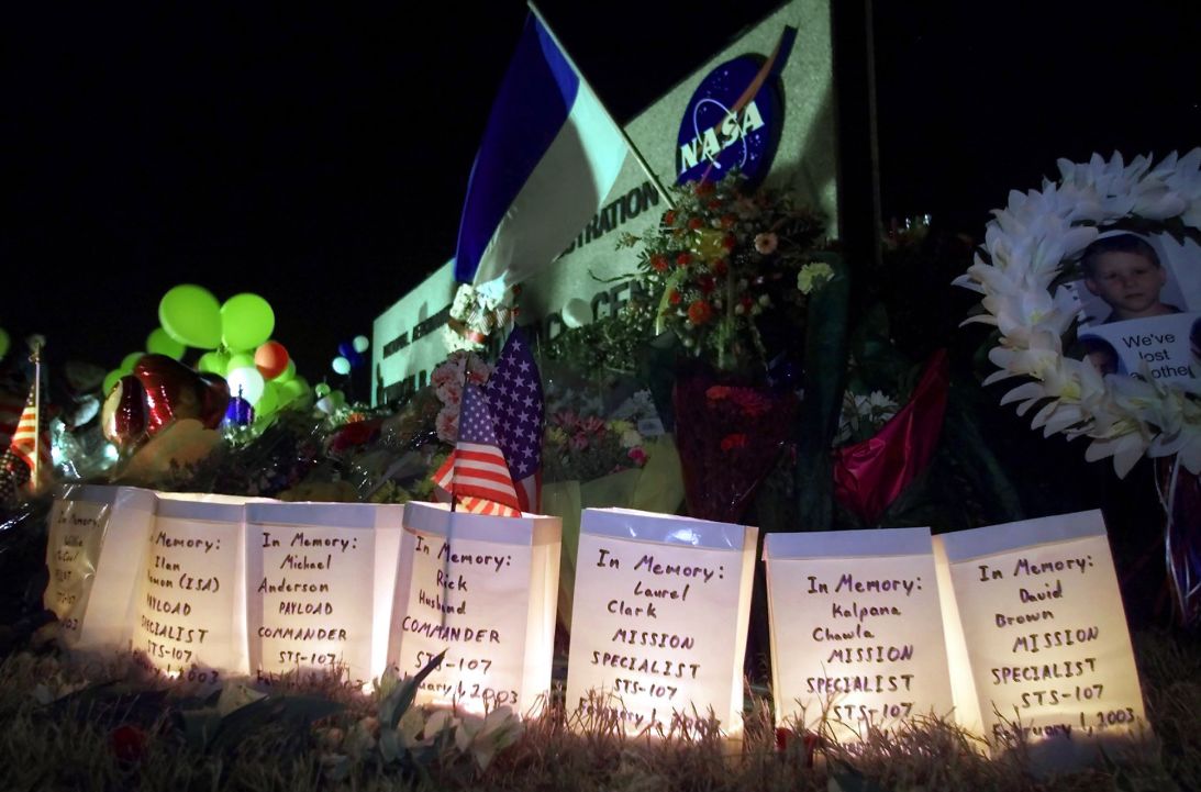 Seven candles burn in paper bags outside NASA's Johnson Space Center in Houston, inscribed with the names of the seven astronauts lost on February 1, 2003, in the Space Shuttle Columbia disaster.