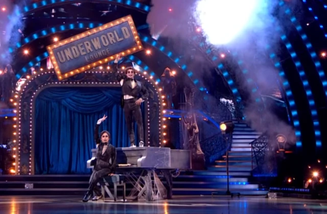 Lewis and Katya in black suits