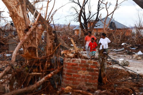 People inspect the damage in the aftermath of Hurricane Melissa, in Black River, Jamaica.