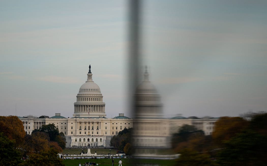 The dome of the US Capitol is reflected in a window as people visit the Washington Monument on November 2.
Mandatory Credit: Kent Nishimura/Reuters via CNN Newsource