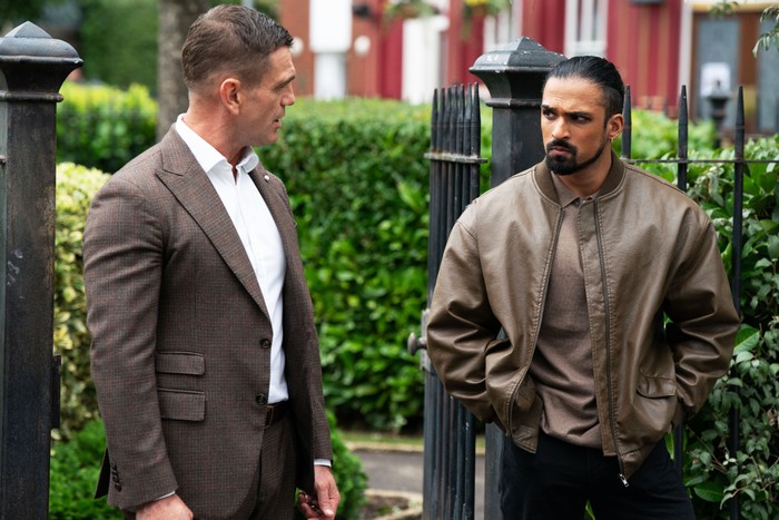 Jack and Ravi look at one another intensely in EastEnders