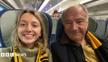 Kate with her father Mark on the train on their way to a Wolverhampton Wanderers football match wearing the merch scarf