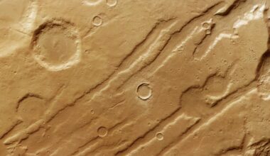 gouges and craters in a reddish orange landscape as seen from overhead