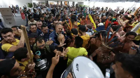 Reuters Protesters try to enter the COP30 venue in Brazil.