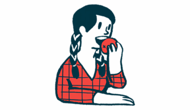 A person prepares to bite into an apple.