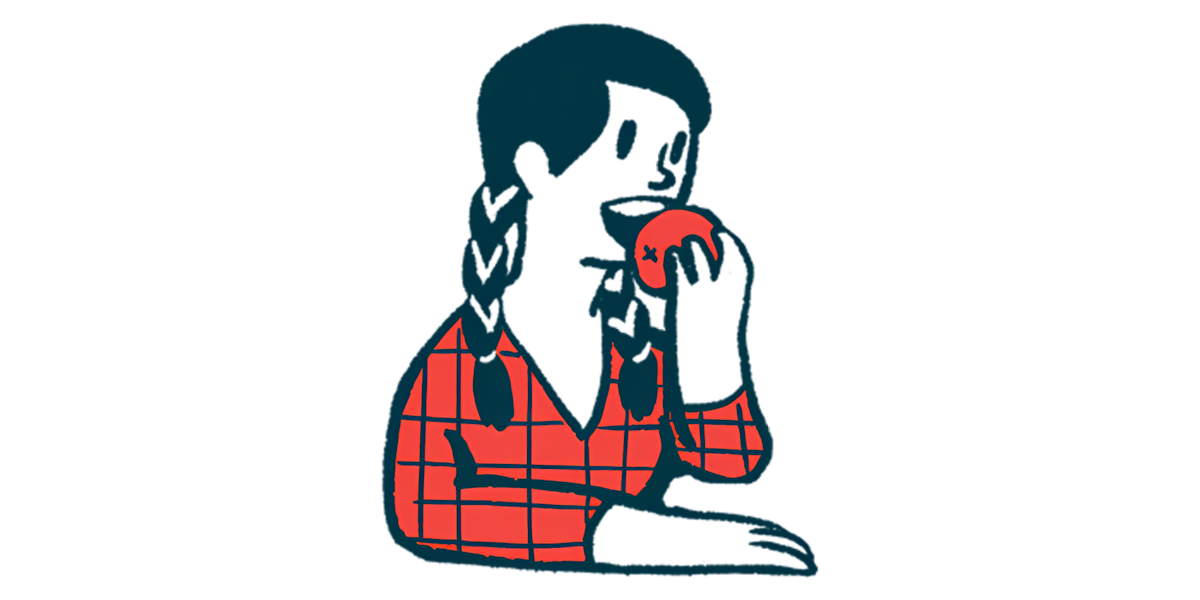 A person prepares to bite into an apple.