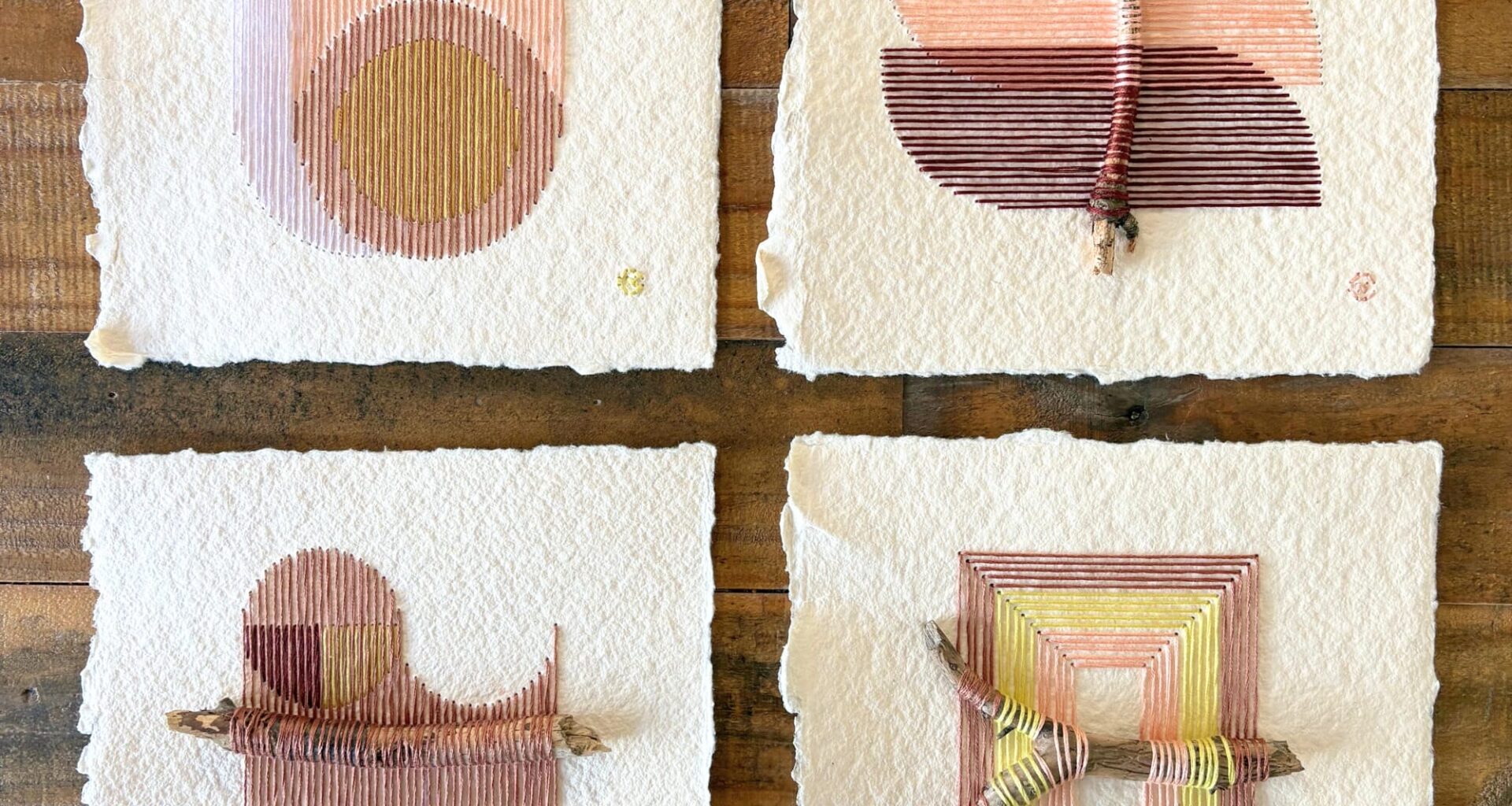 four paper artworks by Natalie Ciccoricco featuring handmade paper and thread wound around found twigs