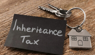 House key with tag labeled “Inheritance Tax” symbolizing property tax concerns for homeowners