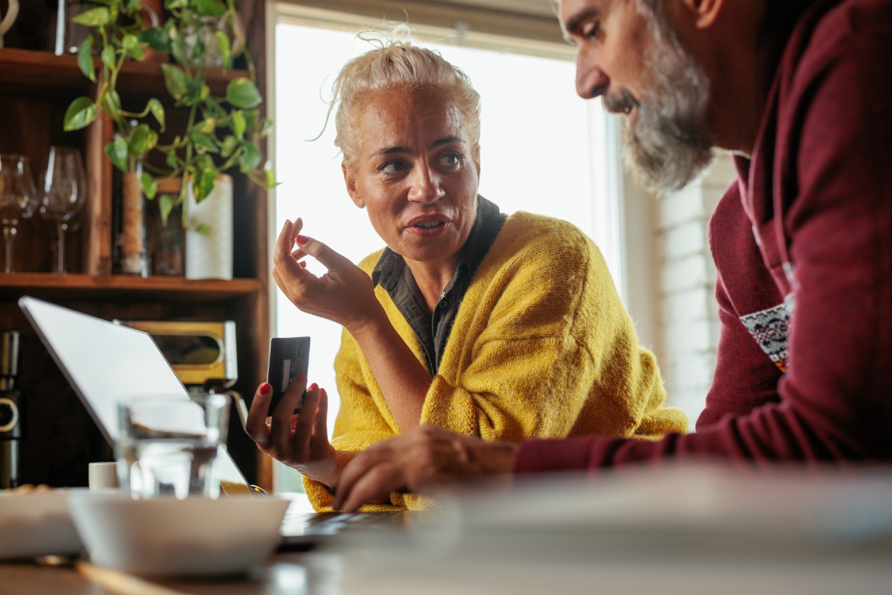 Middle aged couple discussing finances in their kitchen.jpg