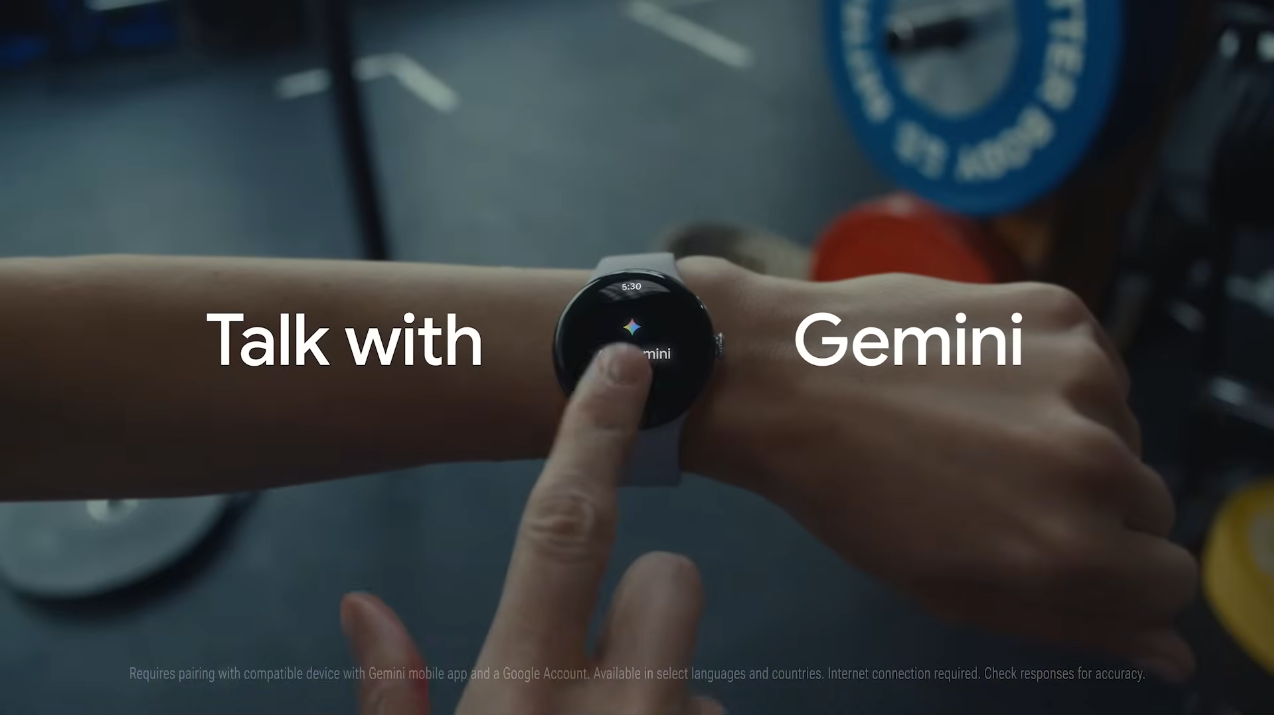Person using a smartwatch showing the Gemini assistant interface with the text "Talk with Gemini" on screen.