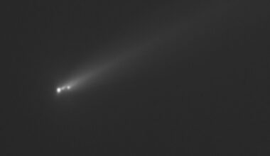 three fuzzy white dots leave a fuzzy trail on a black background