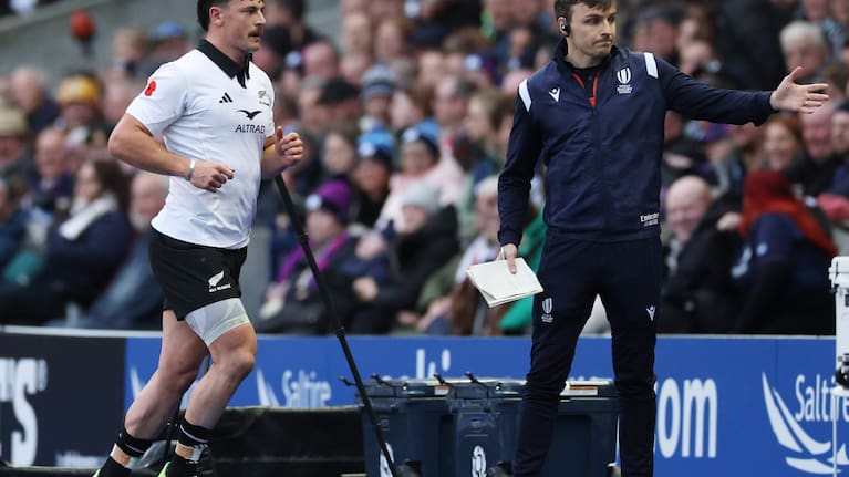 All Blacks wing Leroy Carter is ushered off the field after being yellow carded against Scotland.