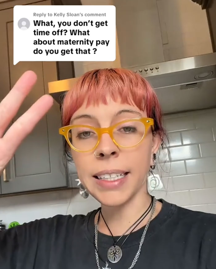 Young woman with pink hair and yellow glasses discusses pay for ambulance rides in a kitchen setting. Young woman with pink hair and yellow glasses discusses pay for ambulance rides in a kitchen setting.