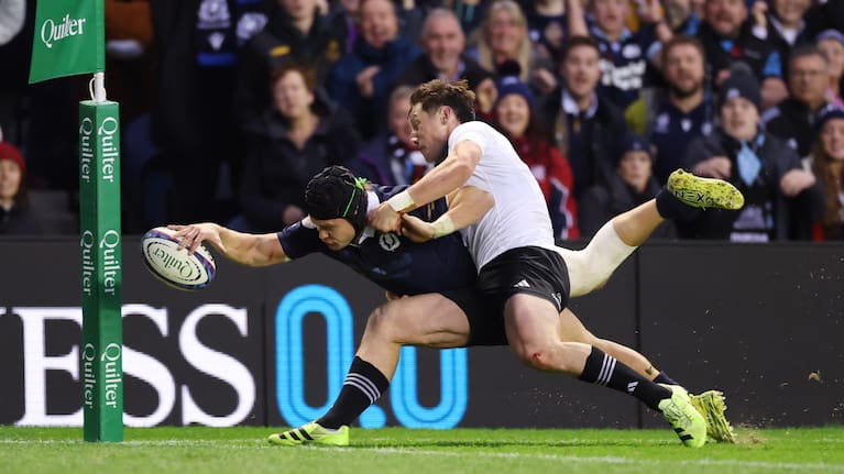 Cam Roigard makes a try-saving tackle on Scotland wing Darcy Graham.