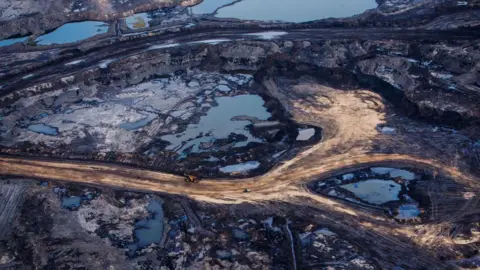 Bloomberg via Getty Images An aerial view of Athabasca oil sands near Fort McMurray, Alberta showing open deposits of oil bitumen along mining service roads. 