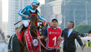 Trainer Danny Shum congratulates James McDonald and Romantic Warrior. Picture: HKJC