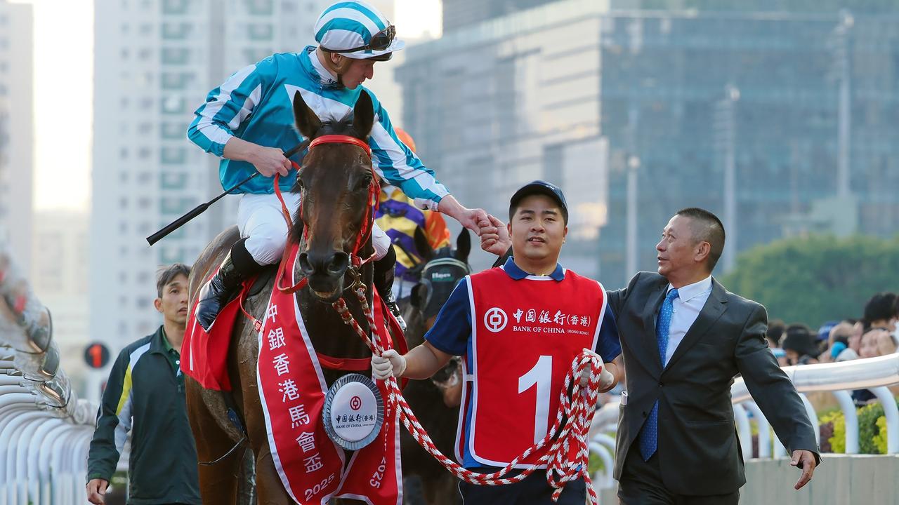Trainer Danny Shum congratulates James McDonald and Romantic Warrior. Picture: HKJC