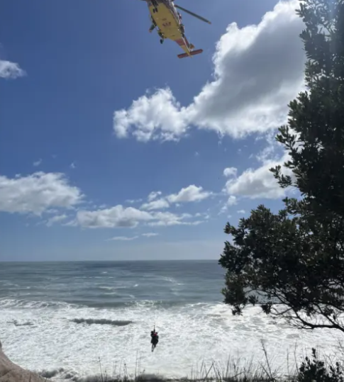 Man taking photos of rescue falls into sea