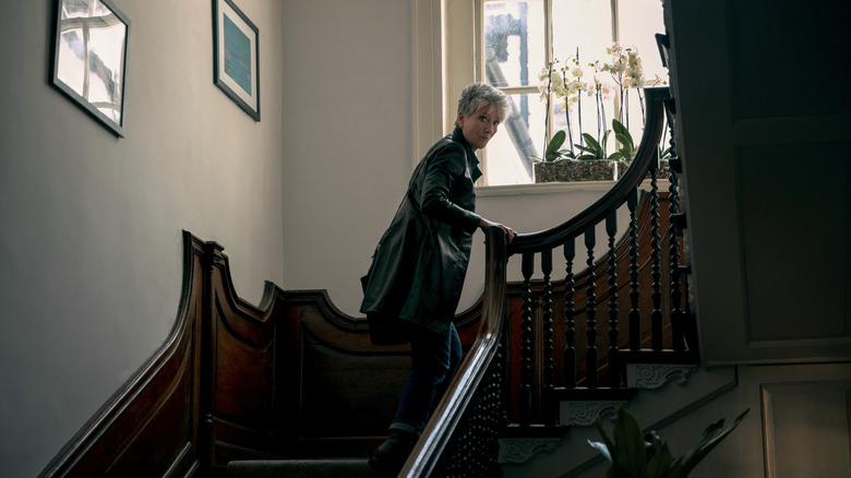 Emma Thompson's Zoë Boehm walks up a staircase in Down Cemetery Road