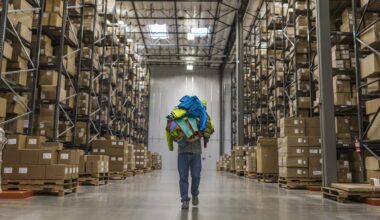 Warehouse with boxes and person carrying garments