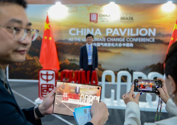 people taking photos of a pavilion at global talks.