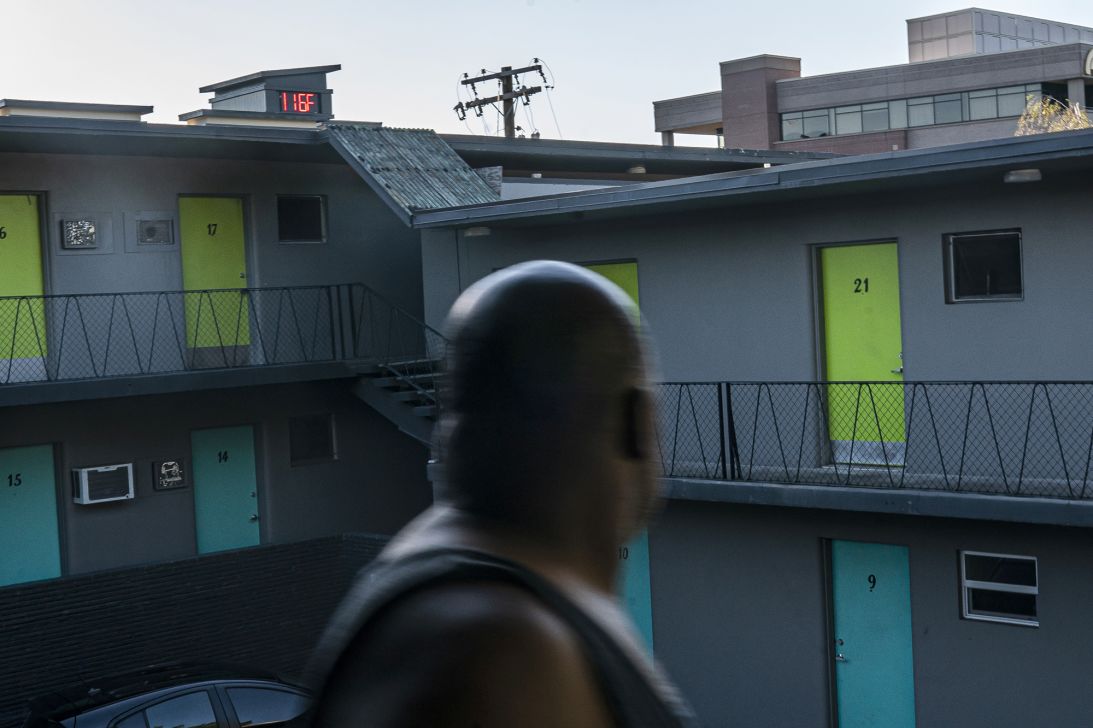 Everett Clayton looks at a digital thermometer on a nearby building that reads 116 degrees on June 27, 2021 in Vancouver, Washington during a historic heat wave.