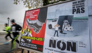 Two illustrated posters in Geneva show opposing views on taxing the super-rich: one advocates for the tax with a giant shoe stepping on people, while the other opposes it, depicting a distressed man beside a van with appliances.