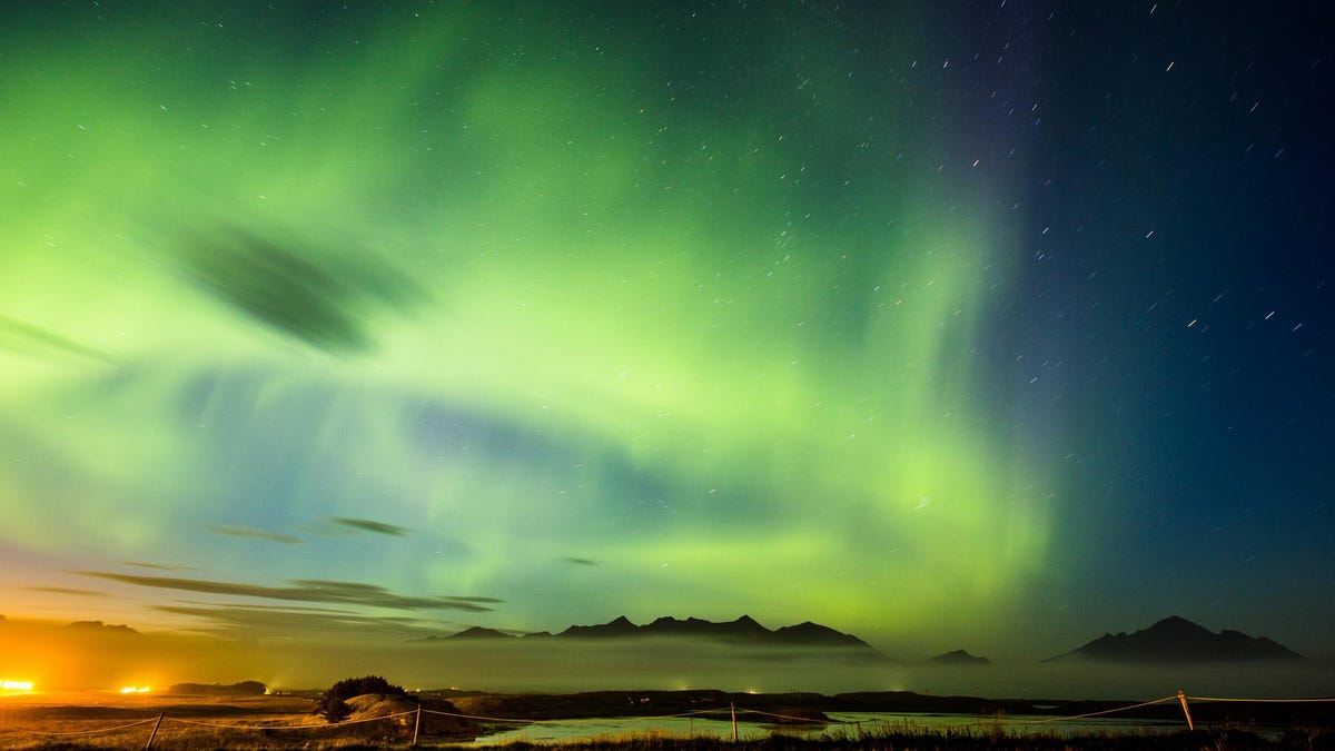 Image of the northern lights over mountains.