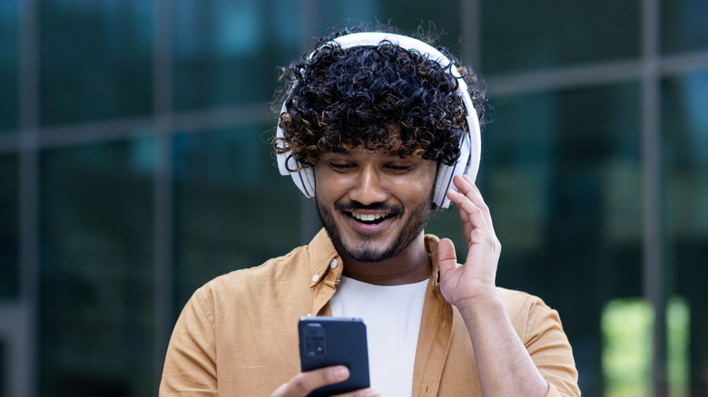 Person listening to audio over headphones